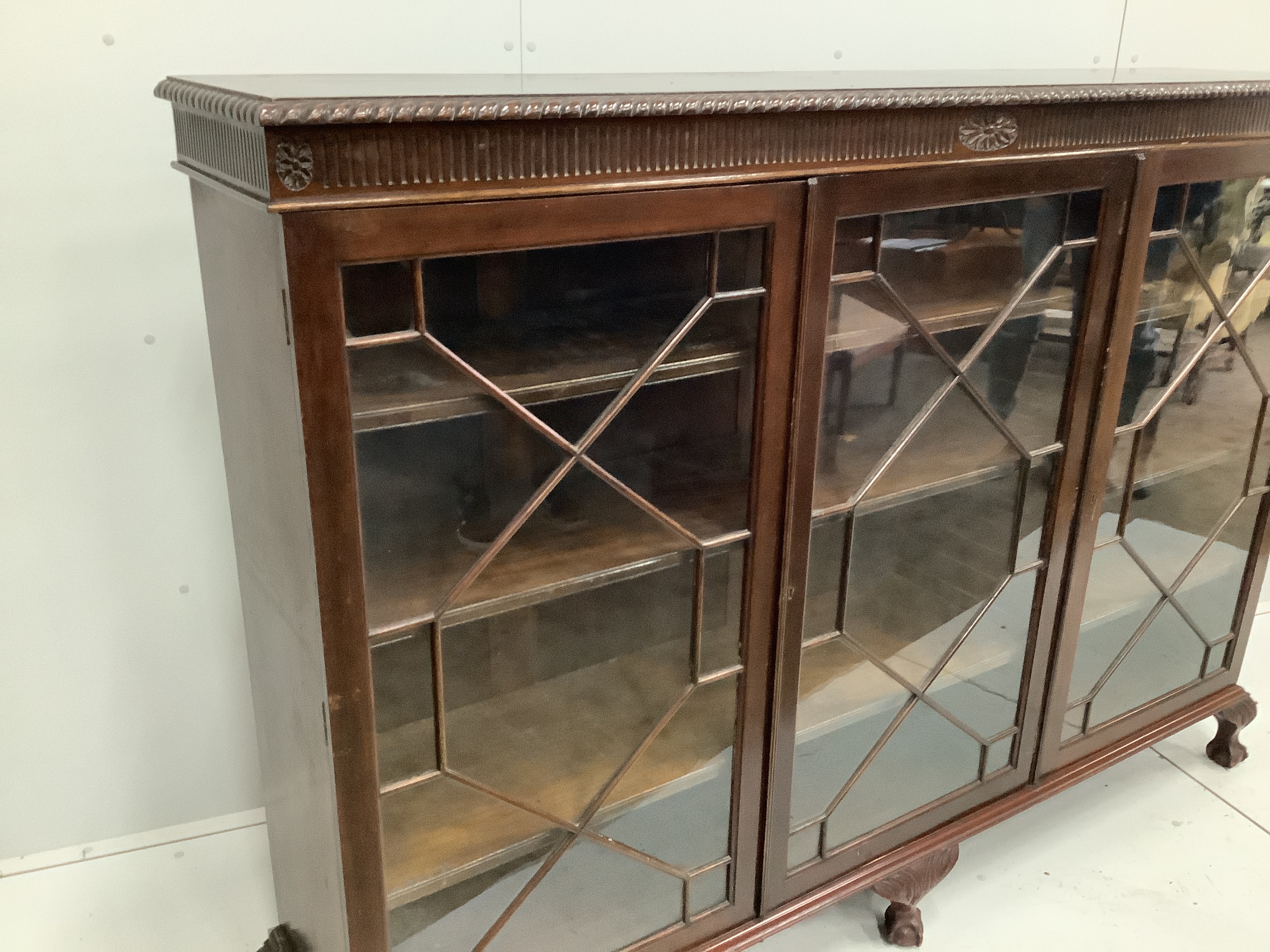 A 1920’s Chippendale revival glazed mahogany bookcase, width 183cm, depth 38cm, height 132cm
